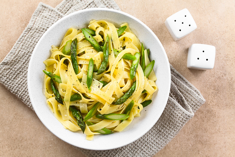Des tagliatelles aux asperges préparées avec de la crème végétale.