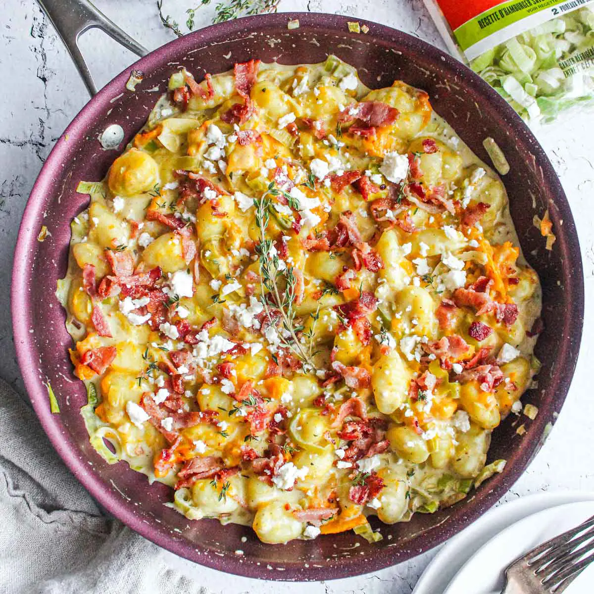 Creamy gnocchi with roasted buttercup squash, leeks and feta, topped with crispy bacon