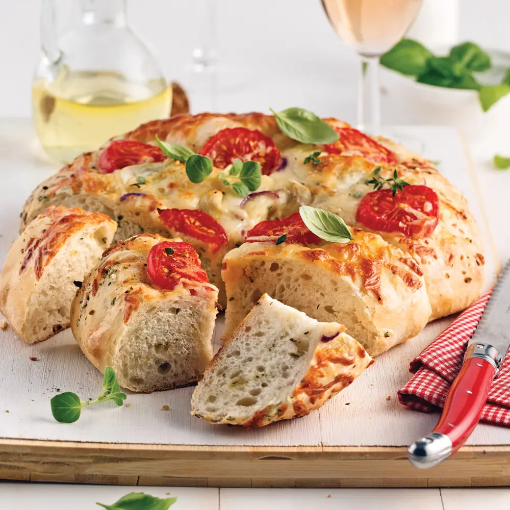 Focaccia with tomatoes, red onion, cheese and herbs