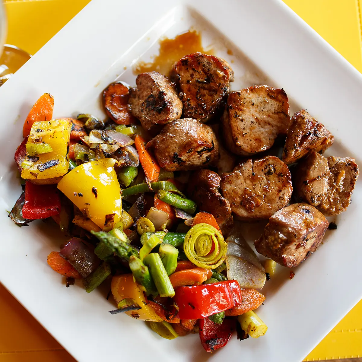 Marinated pork tenderloin medallions with seasoned vegetables